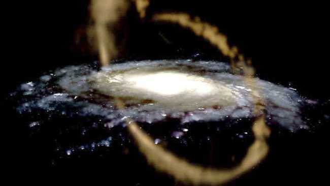 Imagens e análises recentes de campo amplo indicam que a Via Láctea ainda está no processo de devorar um de seus vizinhos satélites mais próximos. Esta vizinha infeliz, a galáxia anã de Sagitário, agora é vista como parte de uma Corrente de Maré de Sagitário maior, um filamento solto de estrelas, gás e possivelmente matéria escura que envolve a Via Láctea. A representação artística do fluxo é mostrada acima. A especulação também sustenta que a anã de Sagitário já foi puxada pelo disco da Via Láctea muito perto da localização atual do nosso Sol