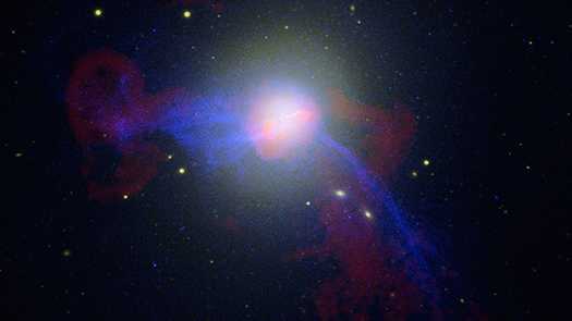 Esta imagem é uma composição de dados de luz óptica, rádio e raios-X da galáxia elíptica gigante M87. Ela fica a uma distância de 60 milhões de anos-luz da Terra e é a maior galáxia do Aglomerado de Virgem, o numeroso conjunto de galáxias que fica na direção da Constelação de Virgem. Jatos brilhantes movendo-se perto da velocidade da luz são vistos, em todos os comprimentos de onda, vindos do enorme buraco negro no centro da galáxia.