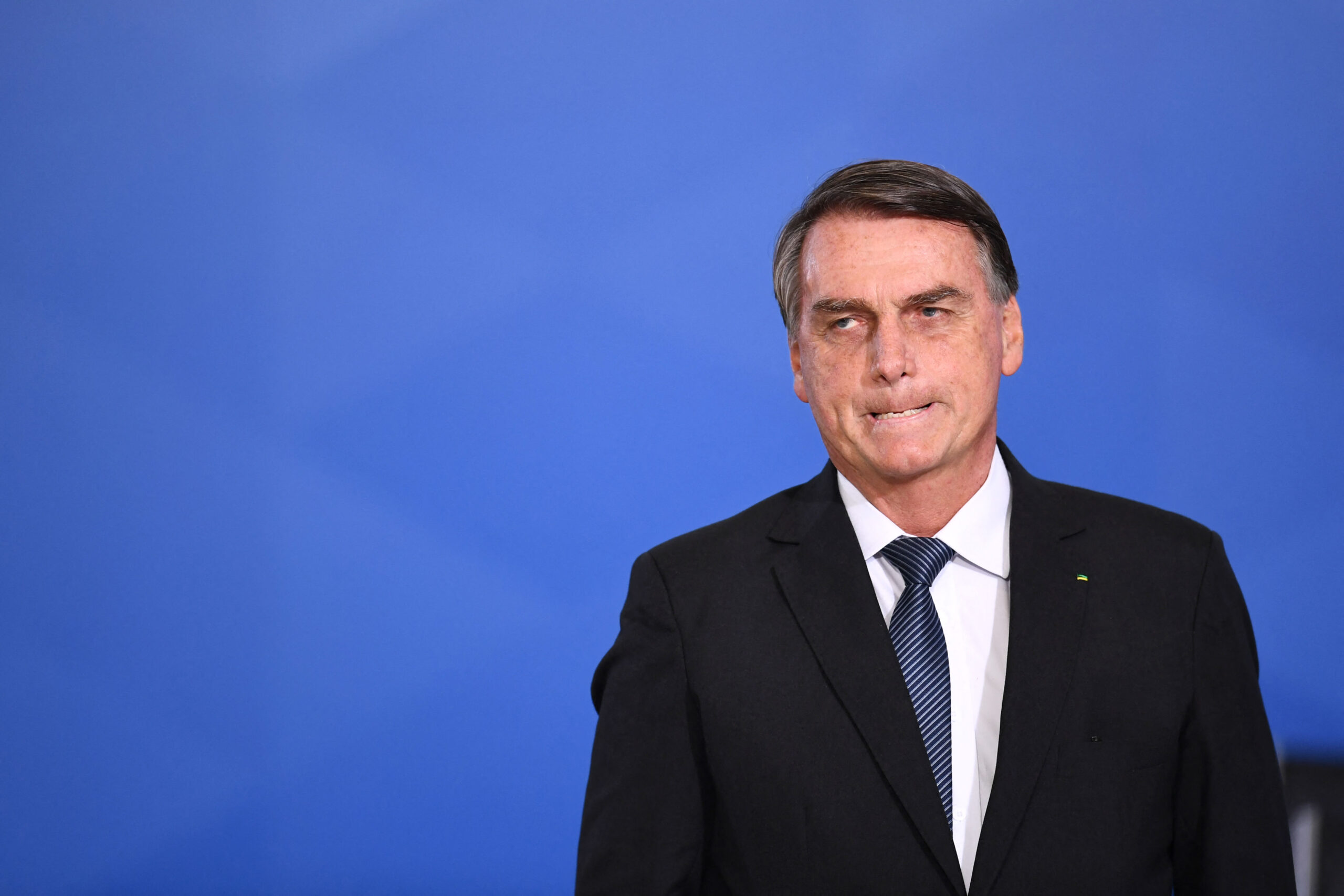 Brazilian President Jair Bolsonaro gestures during the promotion ceremony of General Officers of the Armed Forces, at Planalto Palace in Brasilia, on August 4, 2022. (Photo by EVARISTO SA / AFP)