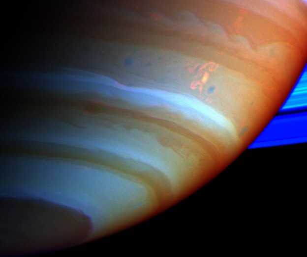 As nuvens complexas vistas em laranja nesta imagem estão próximas ao hemisfério sul de Saturno. Chamada de Tempestade do Dragão, ela é responsável por explosões misteriosas de rádio e foi monitorada pelos instrumentos da Cassini, enquanto a espaçonave orbitava o planeta dos anéis. Trata-se de uma gigantesca tempestade saturniana com descargas elétricas de alta voltagem. A Tempestade do Dragão é um fenômeno de longa duração, nas profundezas da atmosfera do gigante gasoso, que explode periodicamente para produzir grandes regiões visíveis