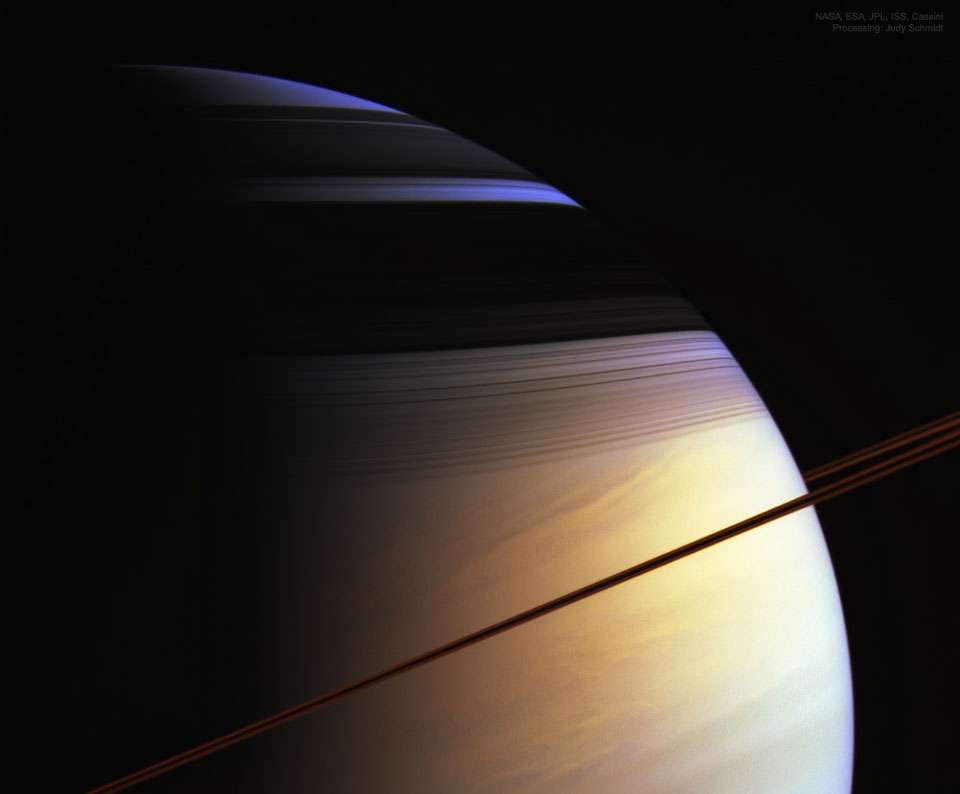 O que cria as cores de Saturno? A imagem em destaque exagera apenas um pouco o que um humano veria se estivesse perto do gigante dos anéis. Registrada em 2005, pela espaçonave Cassini, ela retrata os majestosos anéis de Saturno como uma linha curva, quase marrom, devido ao seu brilho infravermelho. Os anéis mostram melhor sua estrutura complexa nas sombras escuras, na parte superior do planeta. O Hemisfério Norte de Saturno parece azul pela mesma razão que os céus da Terra mostram-se azulados: as moléculas nas porções sem nuvens da atmosfera espalham melhor a luz azul do que a vermelha. Ao olhar profundamente nas nuvens de Saturno, no entanto, a tonalidade dourada natural torna-se dominante