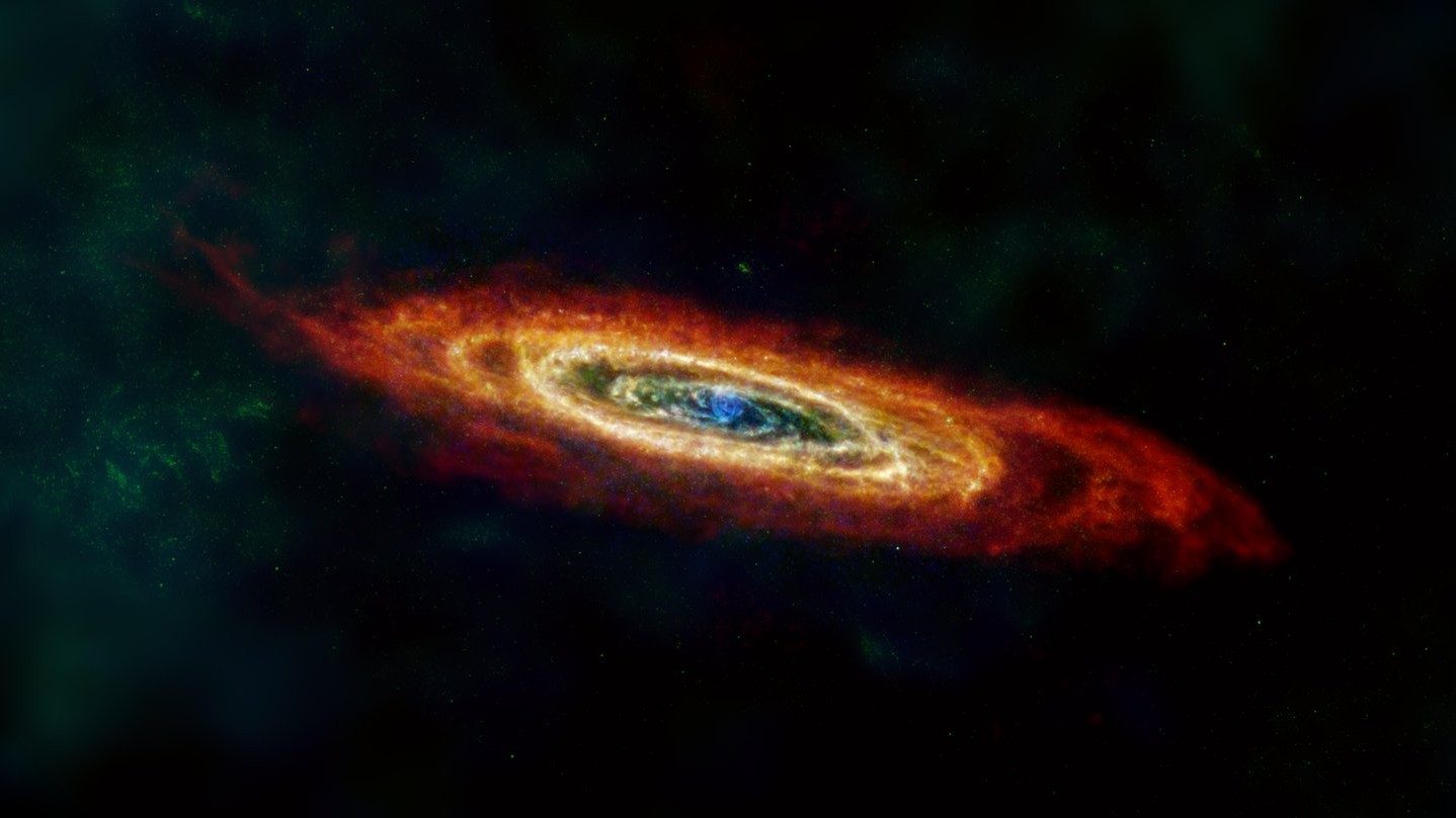 Esta imagem da galáxia de Andrômeda (M31 ou NGC 224) inclui dados de diferentes missões e equipamentos de observação espacial. Nela, o vermelho indica o gás hidrogênio, verde indica poeira fria e a poeira mais quente é mostrada em azul. Galáxia espiral mais próxima da Terra, M31 está a cerca de 2,54 milhões de anos luz de distância, na direção da Constelação de Andrômeda. Esta vizinha galáctica também integra o Grupo Local, do qual é parte a nossa Via Láctea e outras cerca de 30 galáxias menores
