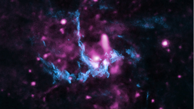 Esta imagem composta apresenta raios X (roxo) e dados de rádio (azul), na região de Sagitário A* (abreviadamente Sgr A*), o buraco negro supermassivo presente no centro da Via Láctea, a nossa galáxia. Nela, vê-se a localização de uma frente de choque, com jatos que se afastam de Sgr A* e viajam pelo espaço até atingir o gás a vários anos-luz de distância. Essa interação também acelera os elétrons, gerando raios X à medida que os elétrons percorrem o caminho do jato, passando pela frente de choque. Sgr A* tem cerca de 4 milhões de vezes a massa do Sol e fica a cerca de 26 mil anos-luz da Terra, na direção da Constelação de Sagitário