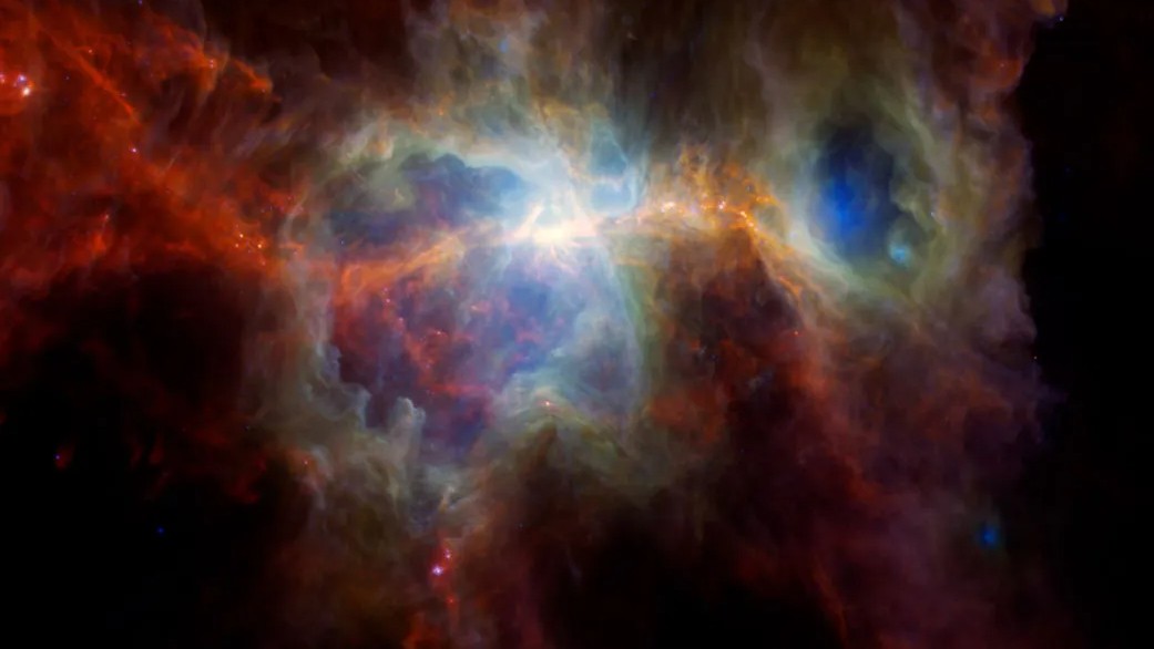 Esta imagem infravermelha da Nebulosa de Órion apresenta muita poeira, mas nenhuma estrela. Nestes comprimentos de onda infravermelhos, é possível ver pontos quentes onde novas estrelas estão se formando, enquanto estrelas massivas, brilhantes e invisíveis escavaram cavernas no espaço vazio. A Nebulosa de Órion está localizada a cerca de 1,6 mil anos-luz de distância, na Constelação de Órion