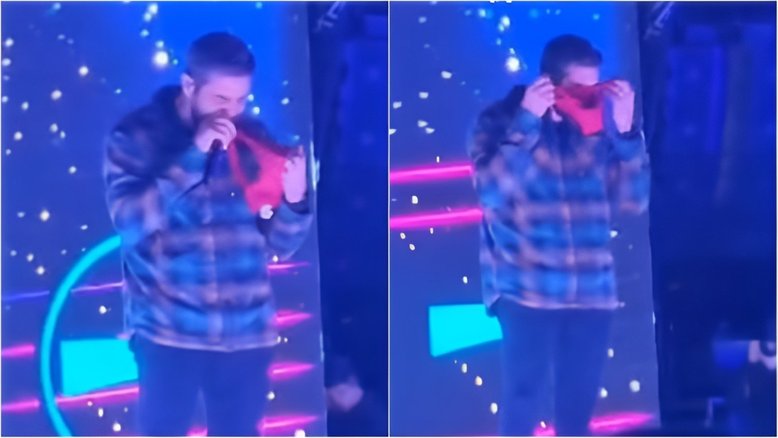 Henrique, da dupla com Juliano, cheira peça íntima lançada no palco durante show