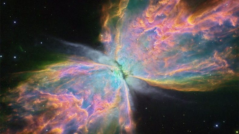 NGC 6302, a Nebulosa da Borboleta, tem uma envergadura gasosa que cobre mais de 3 anos-luz, com uma temperatura superficial estimada que ultrapassa 200 mil graus Celsius. A sua envelhecida estrela central tornou-se excepcionalmente quente, brilhando intensamente na luz visível e ultravioleta, mas escondida para a observação direta pela poeira. Esta imagem, registrada pelo Telescópio Espacial Hubble, foi processada para mostrar detalhes notáveis ​​da complexa nebulosa planetária, destacando em particular a luz emitida pelo oxigênio (azul), hidrogênio (verde) e nitrogênio (vermelho). NGC 6302 fica a cerca de 3,5 mil anos-luz de distância, na Constelação de Escorpião
