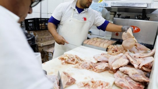 Chicken vendors work in a market in Sao Paulo