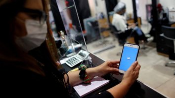 Mulher utiliza app do Mercado Pago em loja em Buenos Aires, Argentina