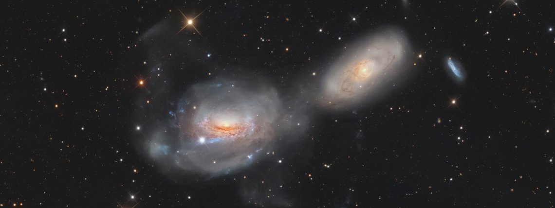 A galáxia espiral NGC 3169 parece estar se desenrolando como um novelo de lã cósmica. Ela fica a cerca de 70 milhões de anos-luz de distância, ao Sul da brilhante Regulus, a estrela Alfa da Constelação de Leão, e em direção à tênue Constelação do Sextante. Braços espirais retorcidos são estendidos em caudas de maré extensas à medida que NGC 3169 (esquerda) e a vizinha NGC 3166 interagem gravitacionalmente, fazendo com que as duas galáxias gradualmente se fundam em uma só. Arcos e plumas estelares alongados são indicações claras das interações gravitacionais em andamento