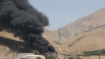 Smoke rises following what Iran says was an Israeli attack on Sharan Oil depot in Tehran