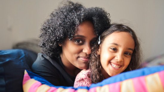 portrait of mother and daughter embraced